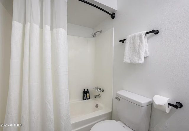 full bathroom featuring shower / bath combination with curtain and toilet