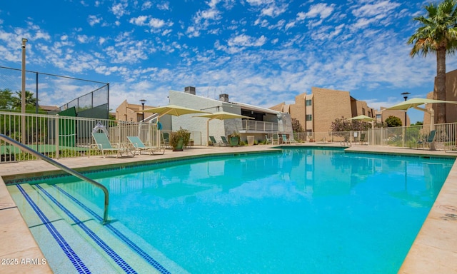 pool featuring fence and a residential view