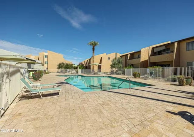community pool featuring a patio area and fence