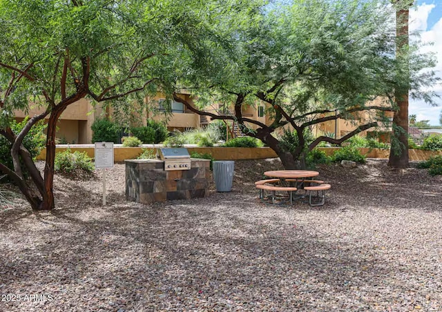 view of patio with area for grilling and a grill