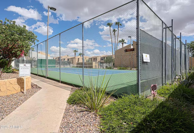 view of sport court featuring fence