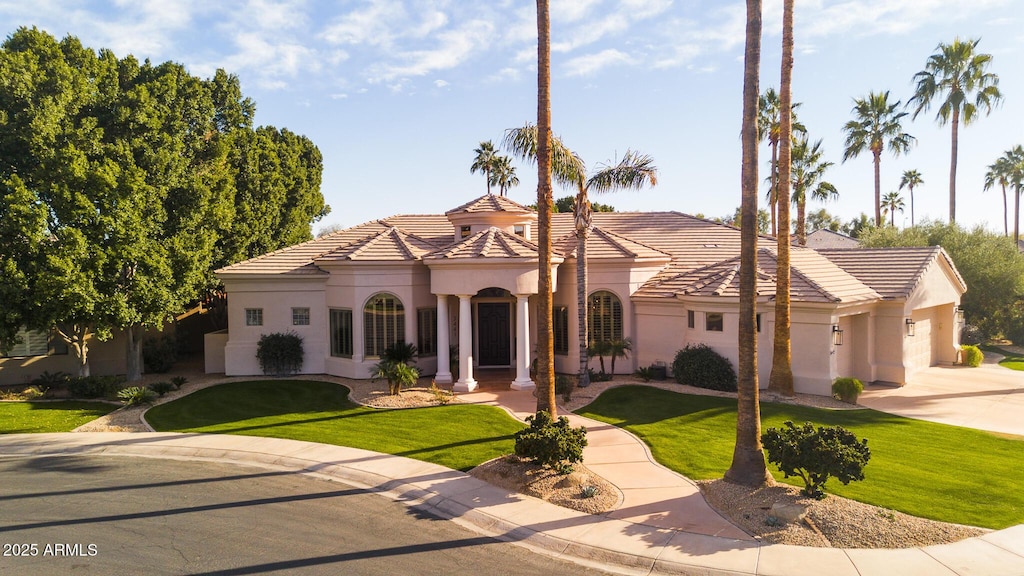 3441 S Camellia Pl, Chandler, AZ 85248 - mediterranean / spanish home with a tiled roof, a front lawn, an attached garage, and stucco siding