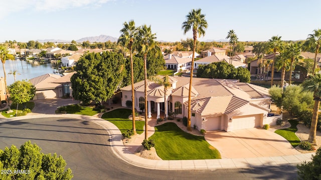 drone / aerial view featuring a residential view and a water view