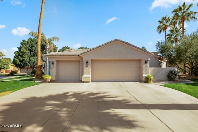 ranch-style house with a garage, a tile roof, and stucco siding