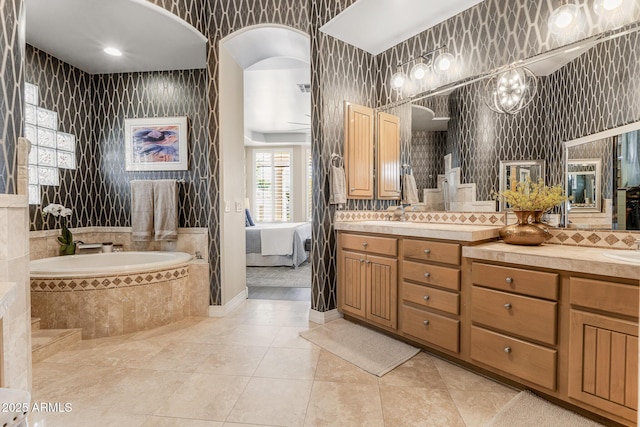 full bath with tile patterned floors, vanity, decorative backsplash, ensuite bath, and wallpapered walls