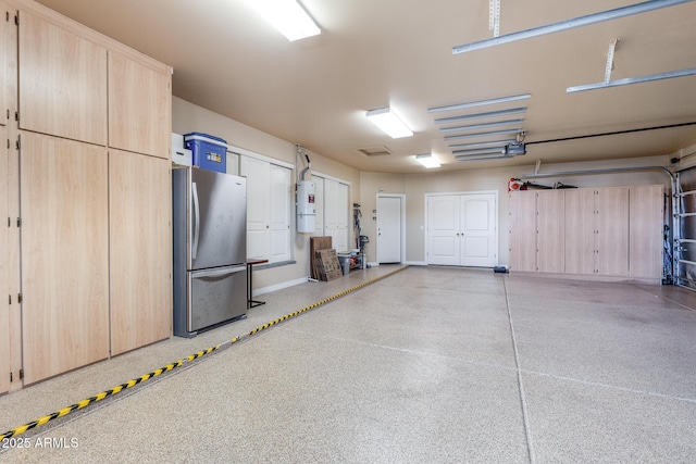 garage featuring a garage door opener and freestanding refrigerator