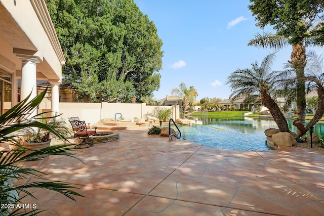 view of swimming pool with a water view, a patio area, a fenced backyard, and a fire pit