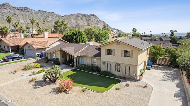 view of front facade with a residential view, brick siding, and a mountain view