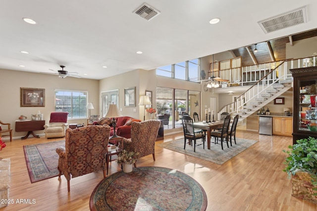 living room with a healthy amount of sunlight, visible vents, and light wood finished floors