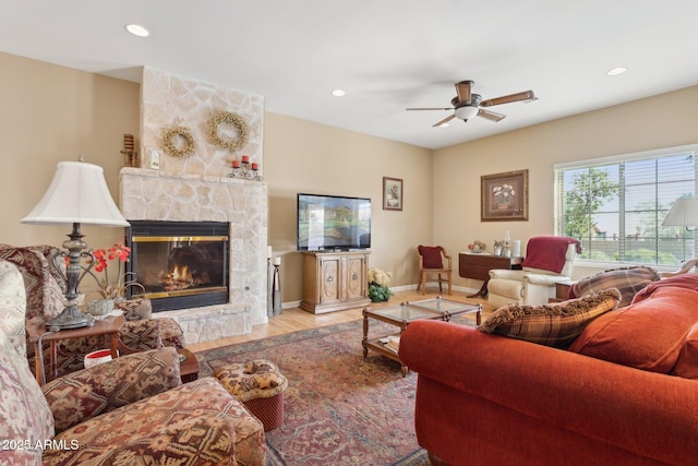 living room featuring recessed lighting, a fireplace, baseboards, and wood finished floors