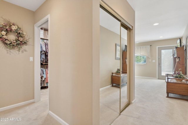 hall featuring recessed lighting, baseboards, and light colored carpet