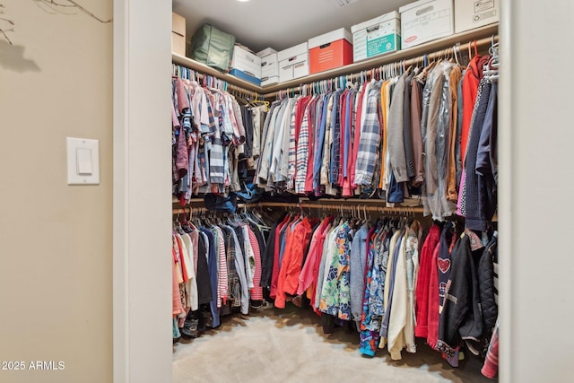 walk in closet with carpet