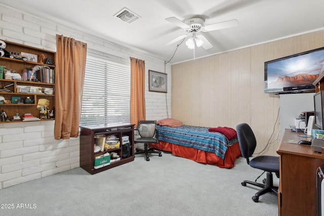 carpeted bedroom featuring ornamental molding, visible vents, and ceiling fan