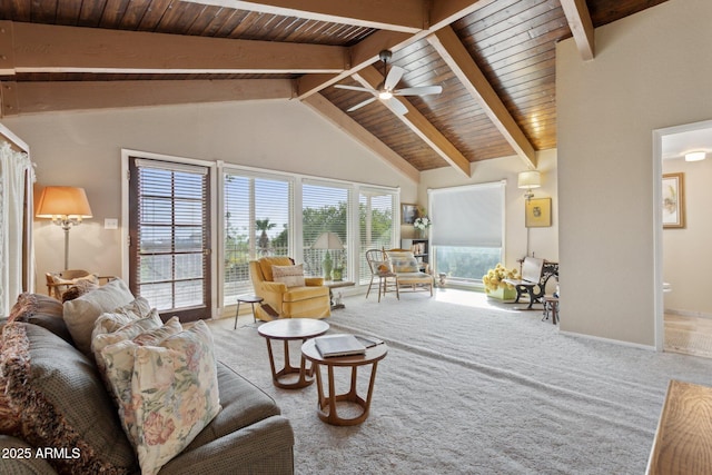 carpeted living room with vaulted ceiling with beams, ceiling fan, wooden ceiling, and baseboards