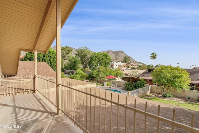 balcony featuring a mountain view and a patio