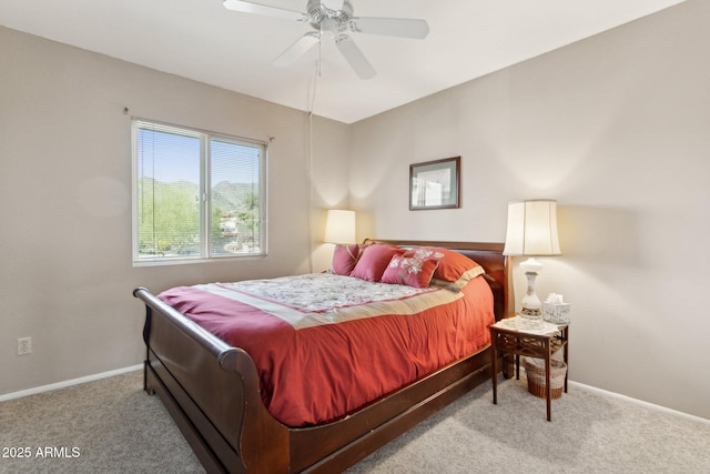 carpeted bedroom featuring baseboards and a ceiling fan