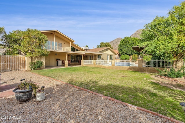 back of property with a yard, a fenced backyard, a patio, and stucco siding