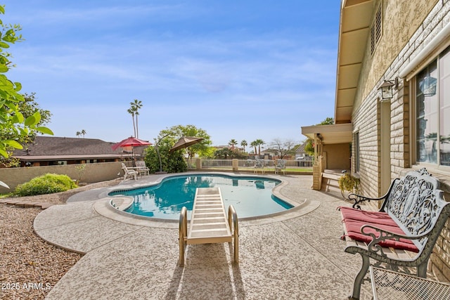 view of swimming pool with a fenced in pool, a patio area, and fence