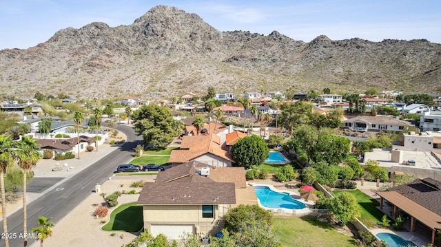 drone / aerial view featuring a residential view and a mountain view