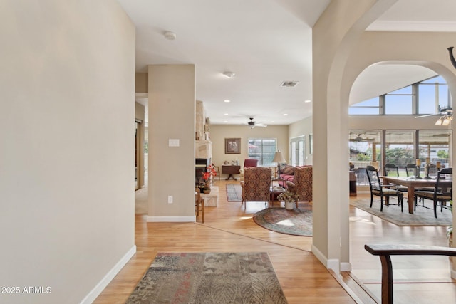 entrance foyer with light wood-type flooring, baseboards, visible vents, and a ceiling fan