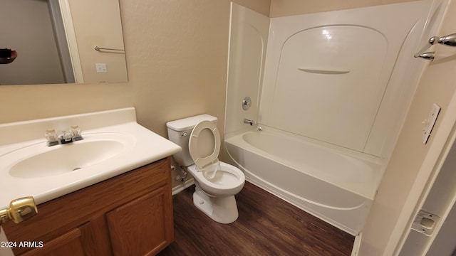 full bathroom with hardwood / wood-style floors, vanity, toilet, and washtub / shower combination