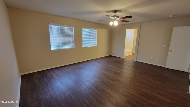 spare room featuring dark hardwood / wood-style flooring and ceiling fan