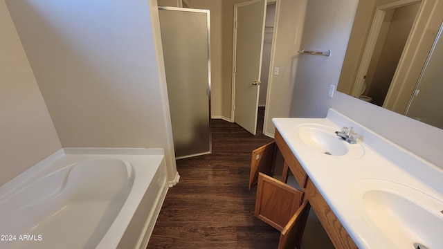 bathroom featuring shower with separate bathtub, hardwood / wood-style flooring, and vanity