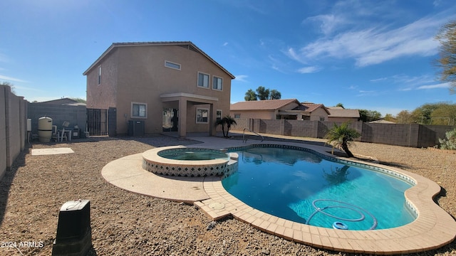 view of swimming pool with a patio and an in ground hot tub