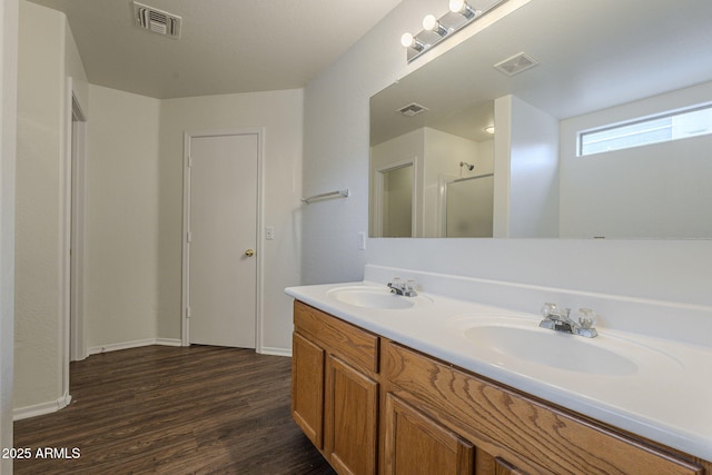 bathroom featuring wood-type flooring, vanity, and walk in shower