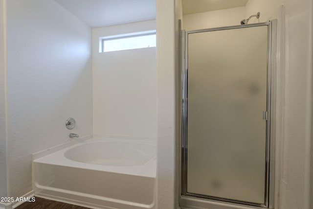 bathroom with shower with separate bathtub