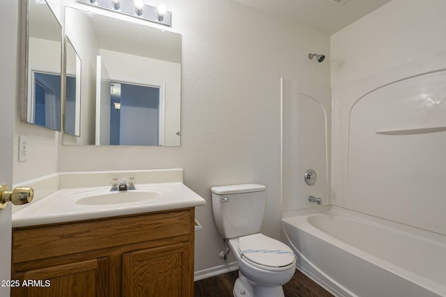 full bathroom with hardwood / wood-style floors, toilet,  shower combination, and vanity