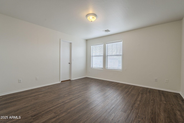 empty room with dark hardwood / wood-style flooring