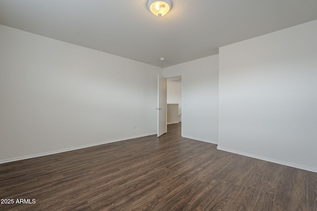 empty room with dark wood-type flooring