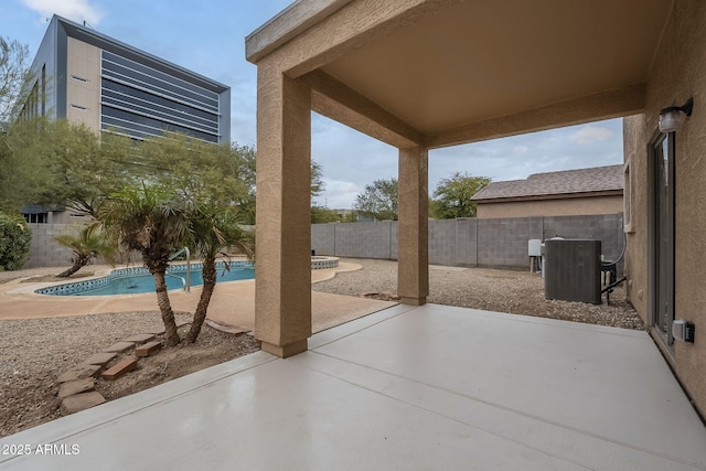 view of patio with central AC unit and a fenced in pool