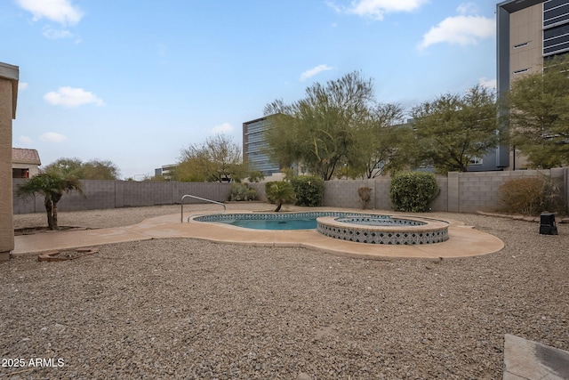 view of yard with a swimming pool with hot tub and a patio area