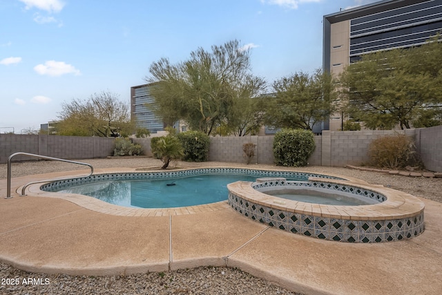 view of pool with an in ground hot tub and a patio area