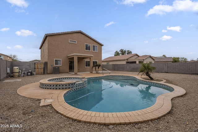 view of swimming pool with an in ground hot tub, a patio, and cooling unit