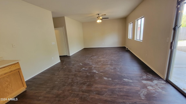 empty room featuring ceiling fan and dark wood-type flooring