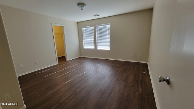 empty room with dark hardwood / wood-style floors