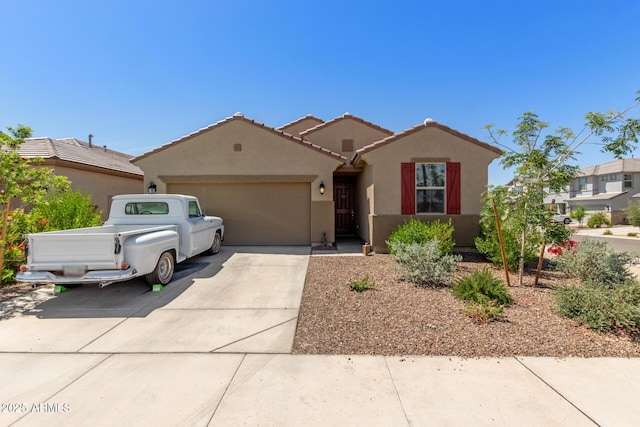 single story home featuring stucco siding, driveway, a tile roof, and a garage