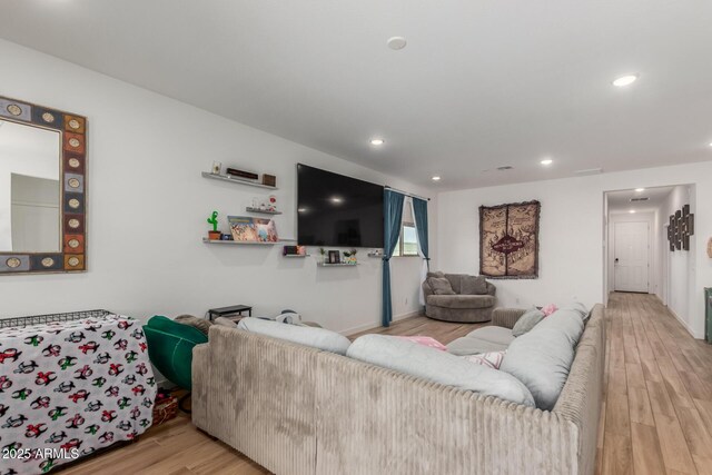 living area with recessed lighting and wood finished floors