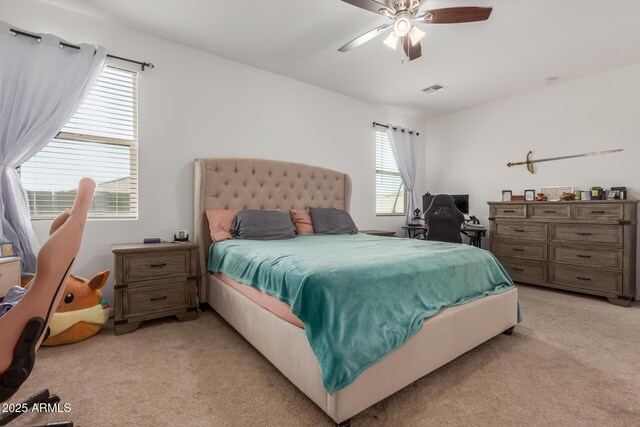 bedroom featuring light colored carpet, multiple windows, and visible vents