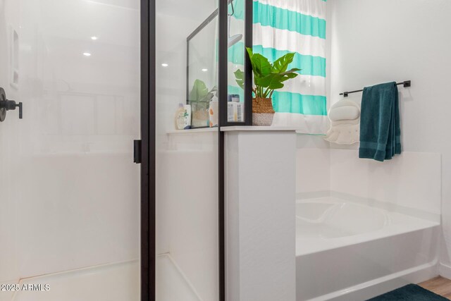 full bath with a bath and a stall shower