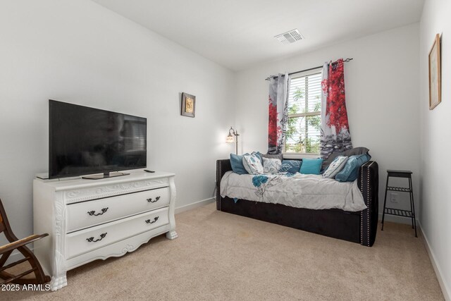 bedroom featuring visible vents, baseboards, and light colored carpet