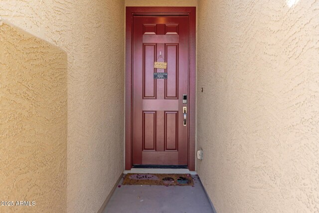 view of exterior entry featuring stucco siding