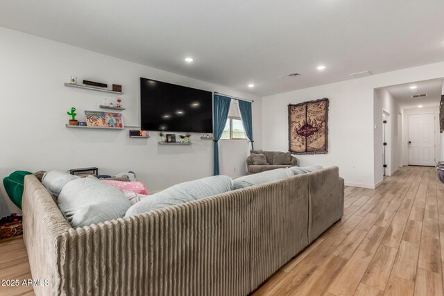 living room with recessed lighting, light wood finished floors, and visible vents