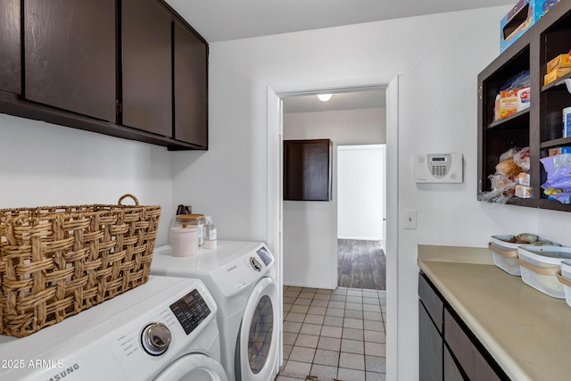 3222 W Hearn Rd, Phoenix, AZ 85053 - washroom with light tile patterned floors, cabinet space, and washing machine and dryer