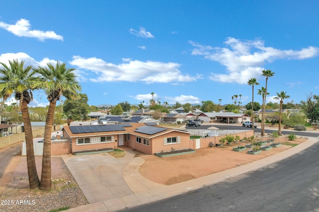 3222 W Hearn Rd, Phoenix, AZ 85053 - view of front facade with stucco siding, solar panels, driveway, and fence