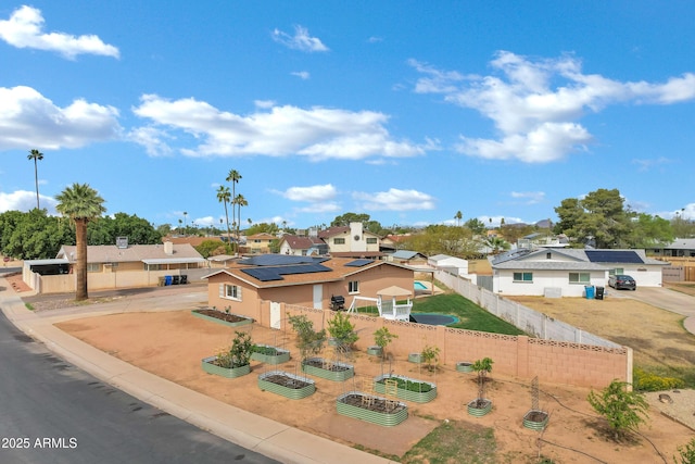 3222 W Hearn Rd, Phoenix, AZ 85053 - view of front facade with a residential view, concrete driveway, fence, and a garden