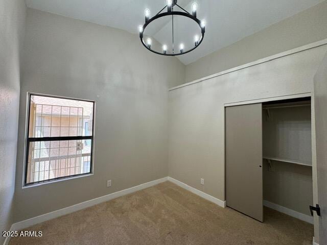 5236 W Peoria Ave Unit 232, Glendale, AZ 85302 - unfurnished bedroom featuring a chandelier, carpet floors, a closet, and a high ceiling